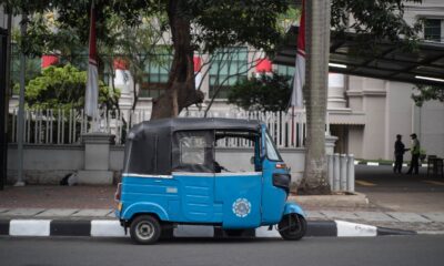 black and blue auto rickshaw on gray concrete road