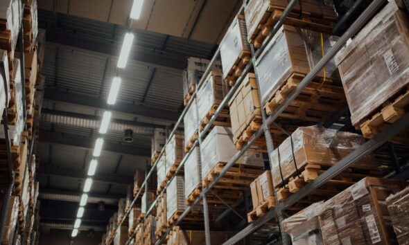 brown cardboard boxes on white metal rack