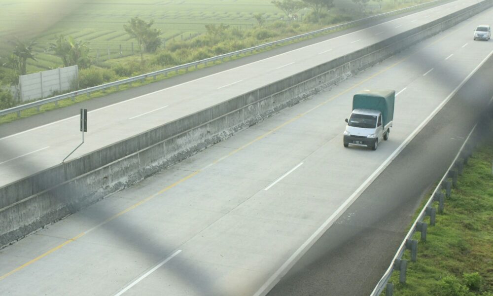 a group of cars driving on a highway