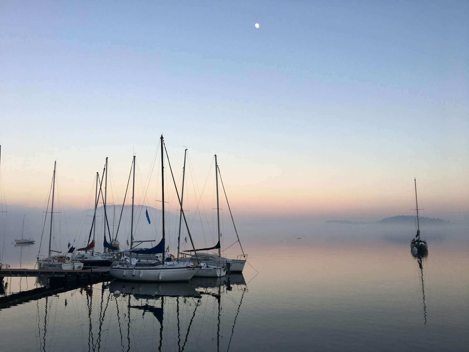 docked white boats during dawn