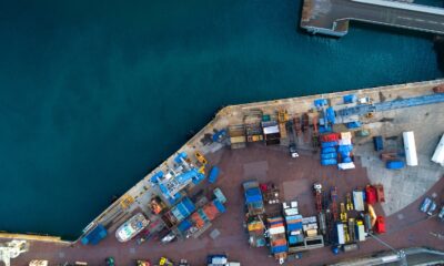 aerial photography of dock containers near body of water during daytime