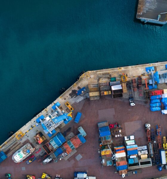 aerial photography of dock containers near body of water during daytime