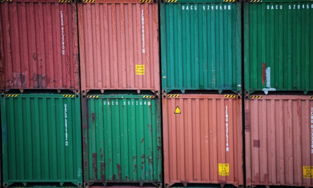 a stack of green and red containers sitting on top of each other