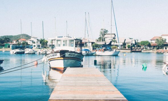 white motorboat near dock