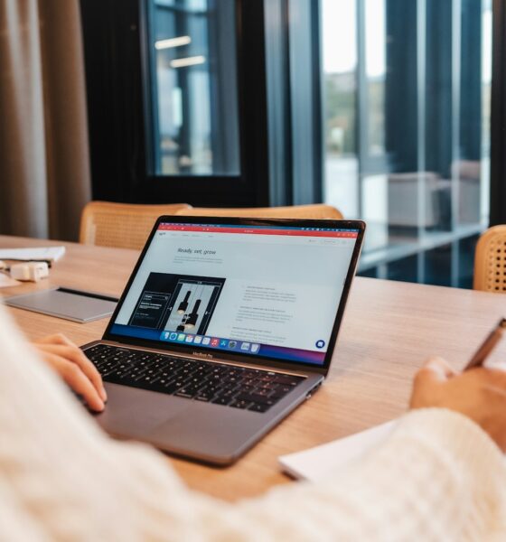 a person sitting at a table with a laptop