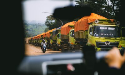 a line of trucks parked on the side of a road