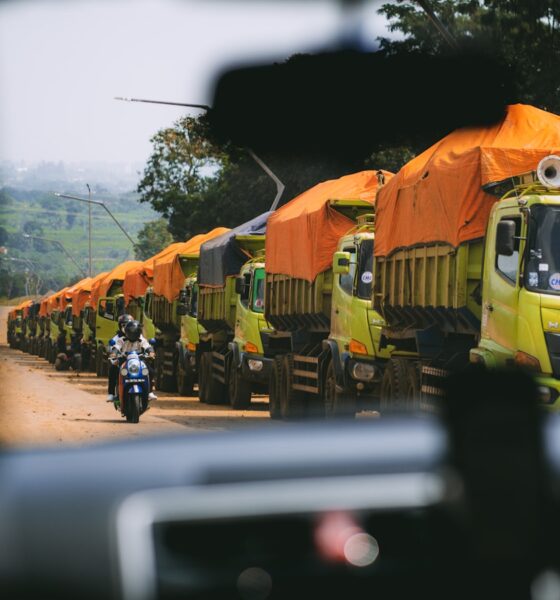 a line of trucks parked on the side of a road