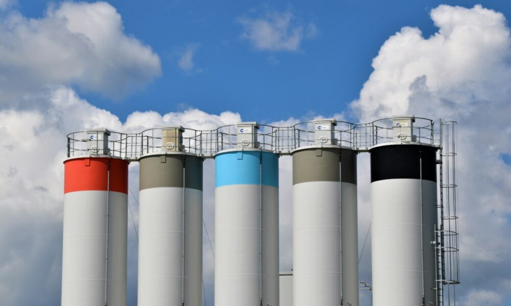 white and blue factory under blue sky during daytime