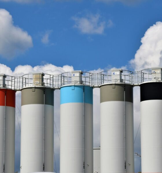 white and blue factory under blue sky during daytime